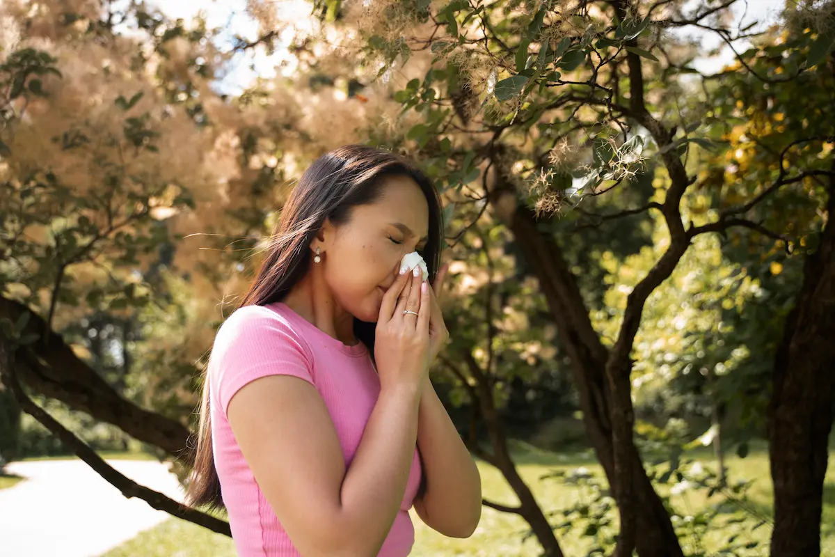 top-non-drowsy-allergy-medicines a woman sneezing wondering what the top non drowsy allergy medicines are