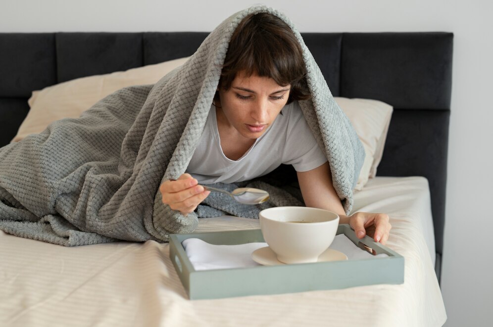 a woman sick with the common cold going through the stages of a cold