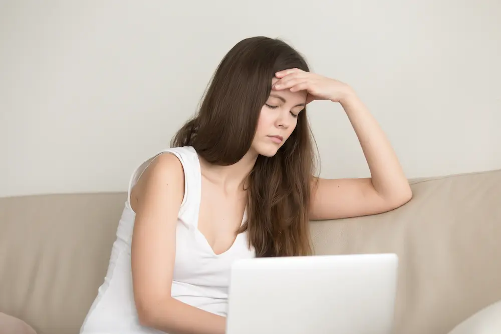 a woman struggling with brain fog taking a brain fog test on her computer