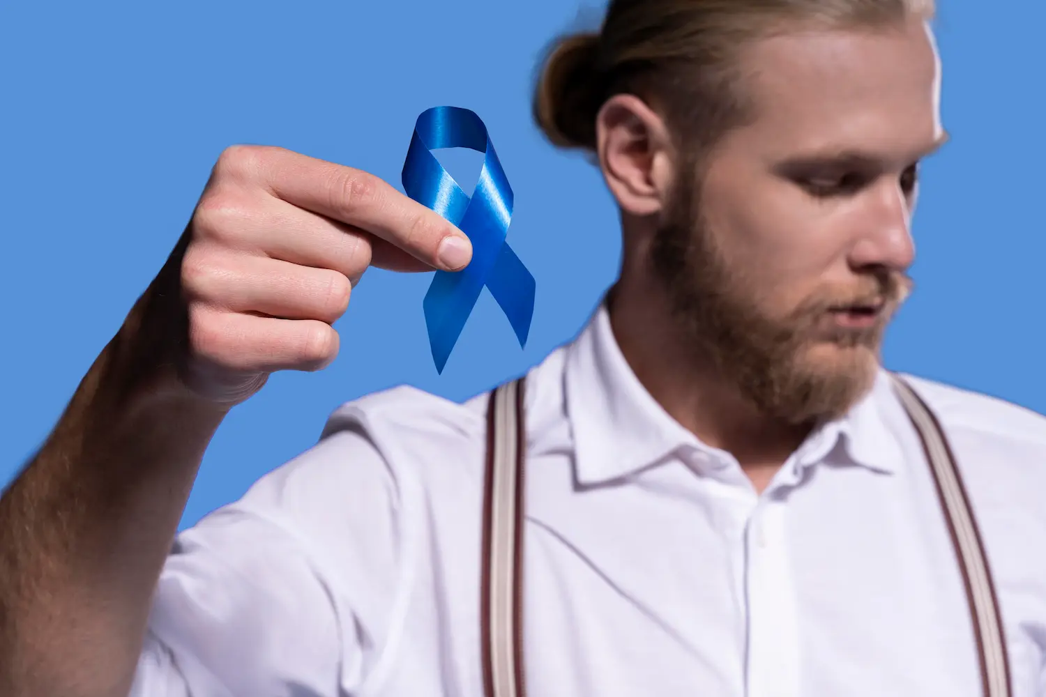 a man holding a prostate cancer ribbon