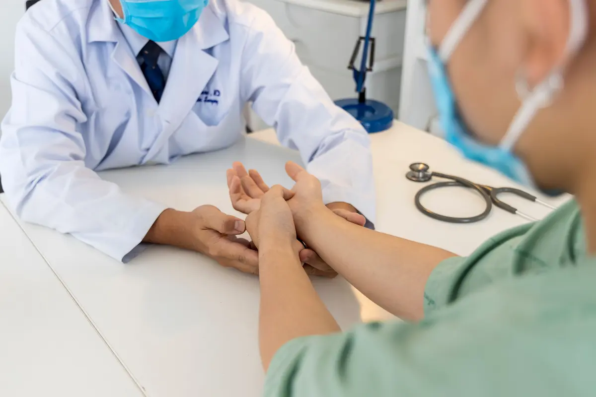 a doctor explaining how to test for carpal tunnel