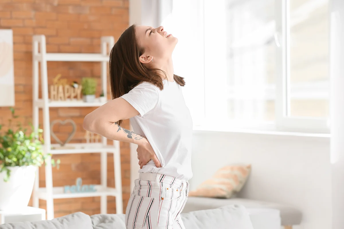 A woman experiencing back pain during ovulation